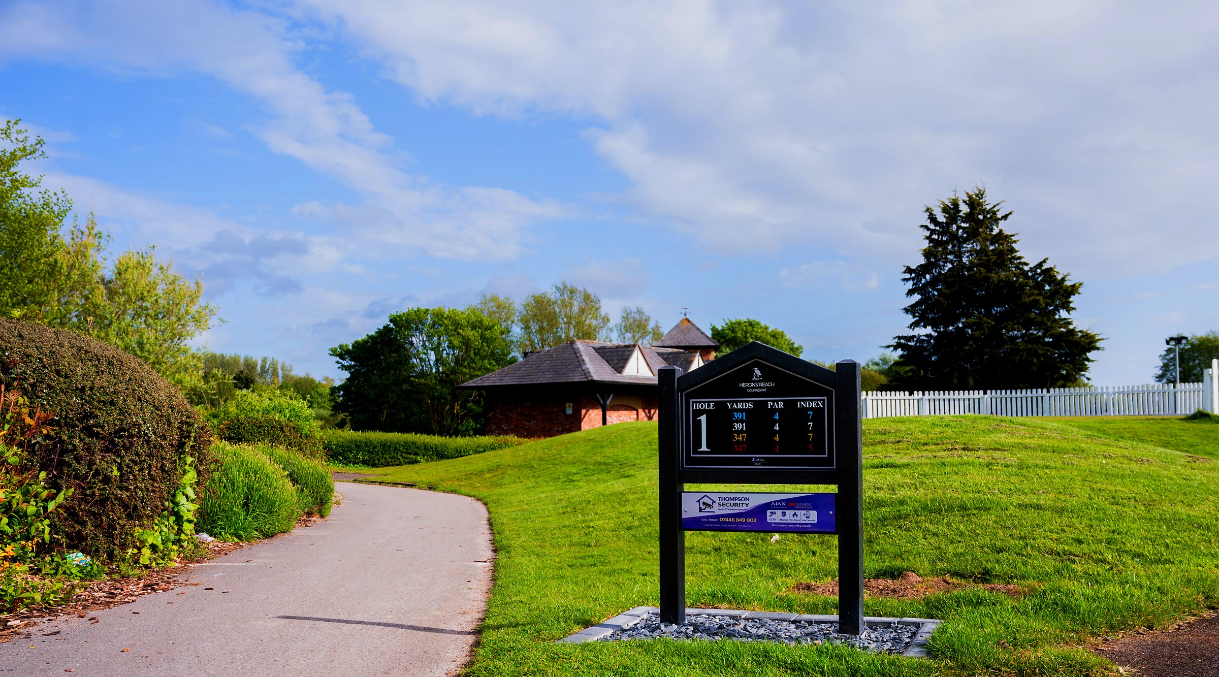 The 1st tee sign at Herons’ Reach Golf Resort, with Thompson Security’s panel beneath it